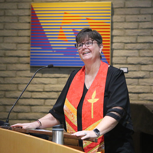 A picture of Reverend Christine at the pulpit during a service.