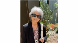 A picture of Sue Kennedy with some Cactus in the background.