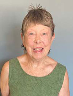 A headshot of Susan Finney against a neutral grey background