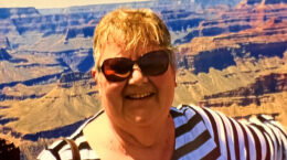 Marg Stallworthy with desert mountains behind her.