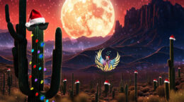 A desert holiday scene with a big moon, the UUCP logo and cactus's decorated with christmas lights